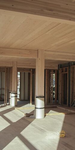 Wood panels and columns in the interior of a building still under construction