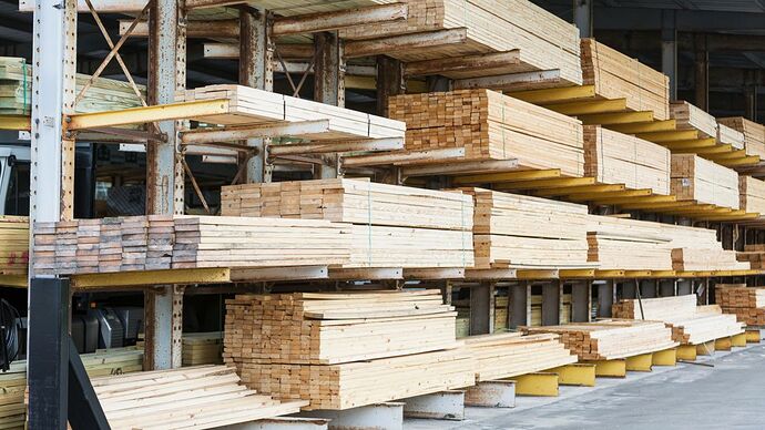 Lumber supplies sit on shelves in a construction supply store.