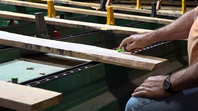 Inspector grades wood at a sawmill in South Pittsburg, TN