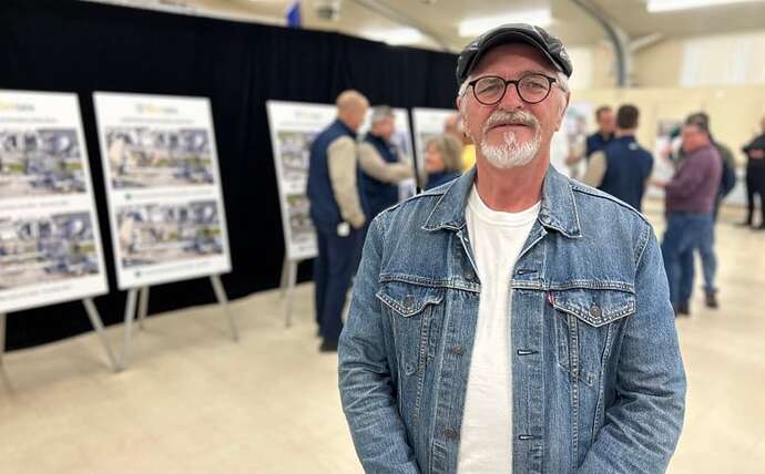 Medium shot of man in jean jacket and hat