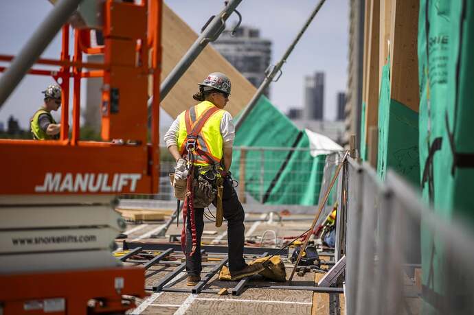 A builder works on the Academic Wood Tower on the University of Toronto campus. Toronto, Ont.