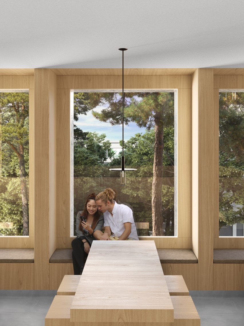Two students sit in a timber-framed window nook at Powerhouse Company's Tilburg University building