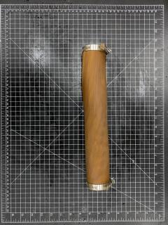 A picture showing a roll of rolled up wood on a grid-like background.