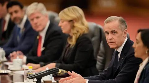 Getty Images Canada's Prime Minister Mark Carney (2nd-R) speaks during a meeting with Chinese President Xi Jinping, at the Great Hall of the People on January 16, 2026 in Beijing, China