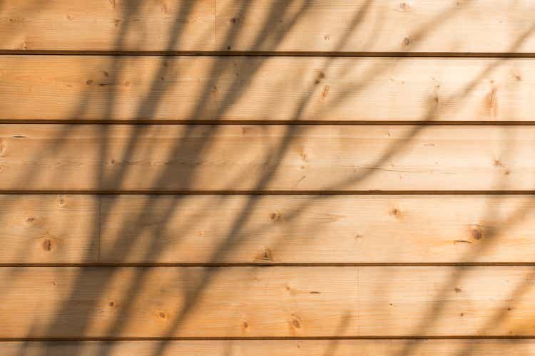 The facade of the house is made of new horizontal wooden boards. Wooden texture. With sunlight and shadows|1536pxx1024px