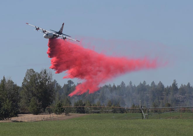 A plane drops fire retardant on the Alder Springs Fire.
