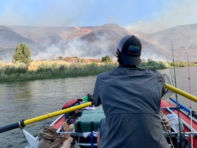 Statesman Journal outdoors reporter Zach Urness rafts through the Ferry Fire on the John Day River on June 13.