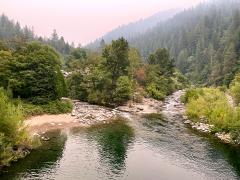 Smoke from the distant 2021 Dixie Fire encases views within a valley with creek that leads to Downieville within the North Yuba Landscape.
